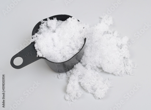 Magnesium nitrate powder on light grey background.