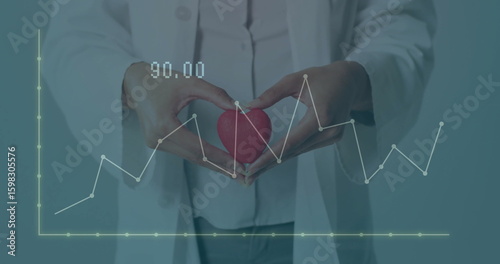 Medical professional holding red heart model while line chart data floating, showing label 90