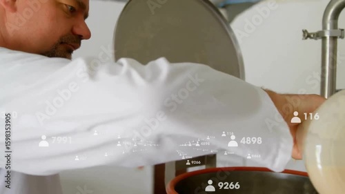 Lab tech positioning glass flask and pouring liquid through sieve into vessel in food processing