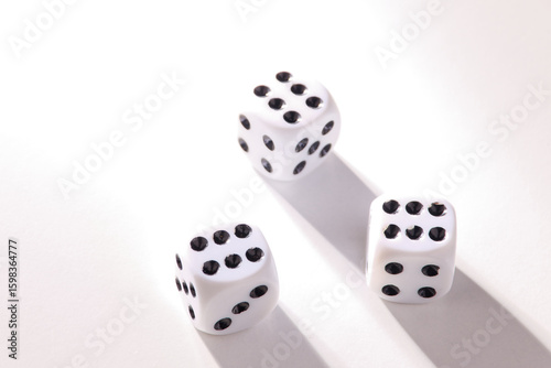 A random arrangement of dice and a puzzle cup, captured after the dice have been cast.