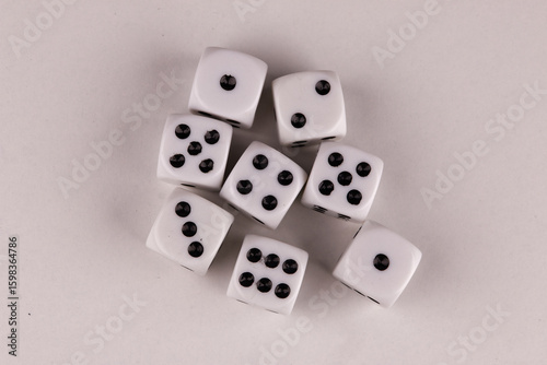 A random arrangement of dice and a puzzle cup, captured after the dice have been cast.