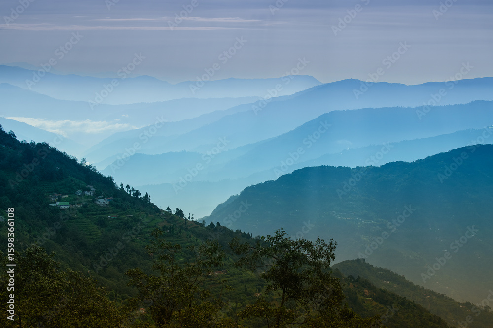 Fototapeta premium Scenic beauty of layers of mountains, Okhrey, sikkim, India. Okhrey village of one of the remotest places in Sikkim where peaceful, tranquil Himalayan mountain range is enjoyed by tourists from India.