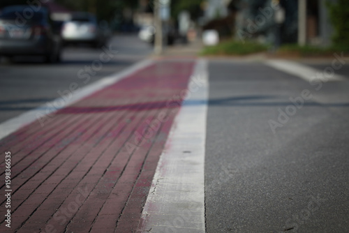 low angle view of a pedestrian crossing with red painted brick on an asphalt street