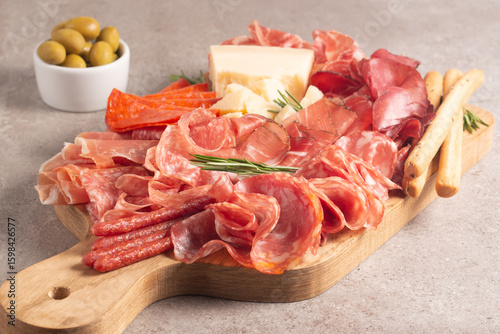 Charcuterie board. Antipasti appetizers of meat platter with salami, prosciutto crudo or jamon and olives.