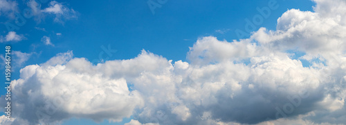 Fotografie Bright blue sky with large fluffy white clouds, creating a panoramic and serene