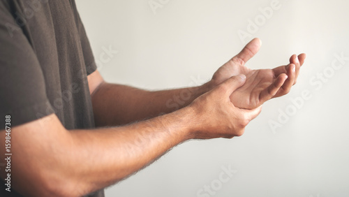 Rheumatism man hand pain from cramp, wrist pain touching massaging, hand holding ache joint