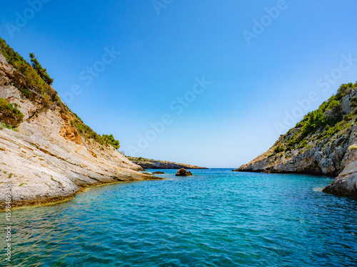 Turquoise waters and rugged cliffs surround the island of Vis, Croatia—an unspoiled Mediterranean escape with lush greenery, perfect for travel, exploration, and coastal serenity.
