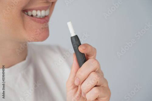 Woman smoking tobacco heating system. Electronic cigarette.