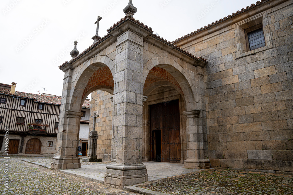Obraz premium Historic Stone Church Facade with Wooden Doors