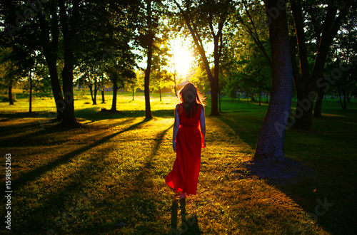 A woman in red go to the sunlight