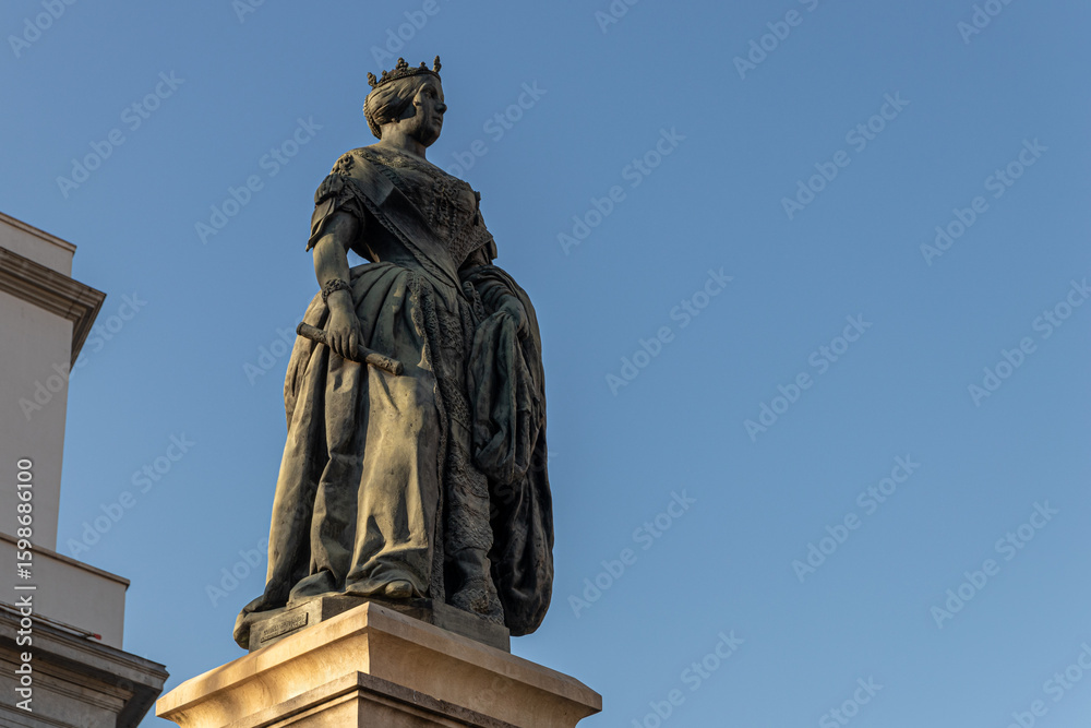 Fototapeta premium Madrid, Spain. Monument to Queen Isabel II in Plaza de Isabel II, in front of the Royal Theatre. Sculpted by Jose Piquer Duart in 1850, it honors the monarch who inaugurated the opera house