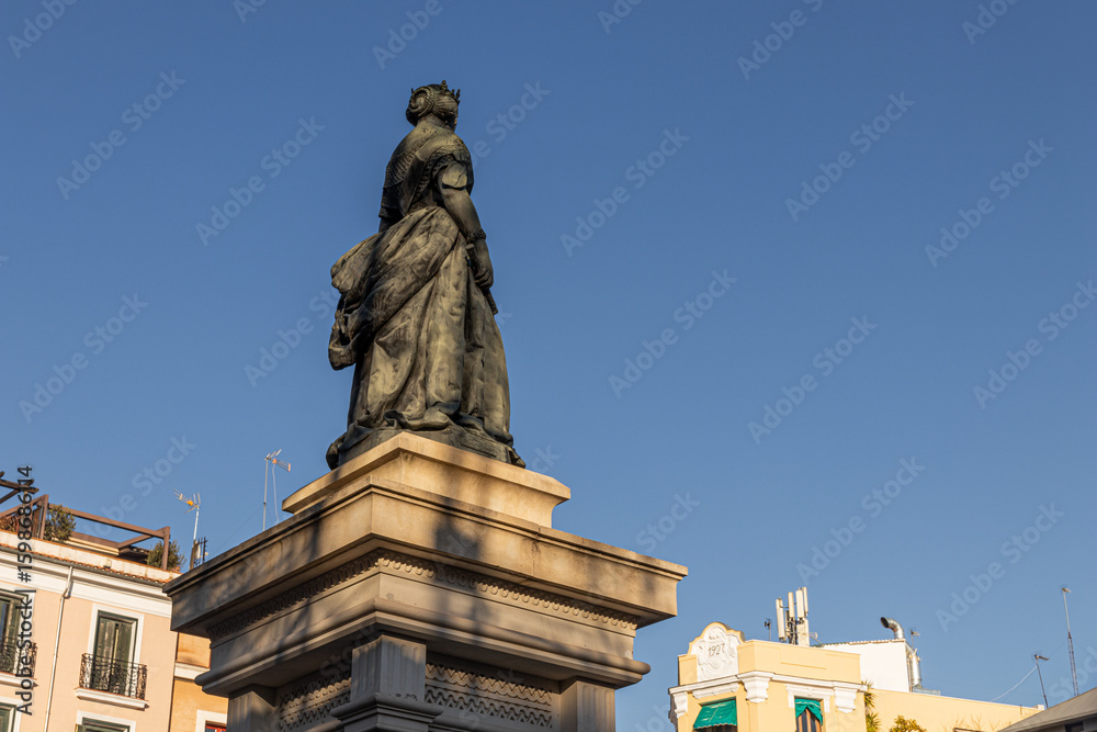 Naklejka premium Madrid, Spain. Monument to Queen Isabel II in Plaza de Isabel II, in front of the Royal Theatre. Sculpted by Jose Piquer Duart in 1850, it honors the monarch who inaugurated the opera house