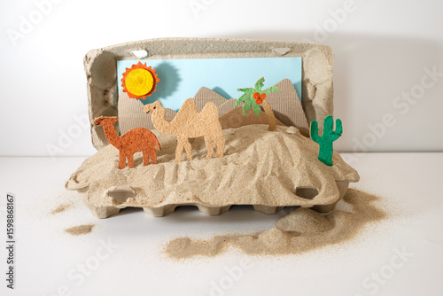 paper camel in DIY desert diorama made from recycled egg carton and craft sand, useful for toy packaging design, homeschool materials, eco craft products, blogs