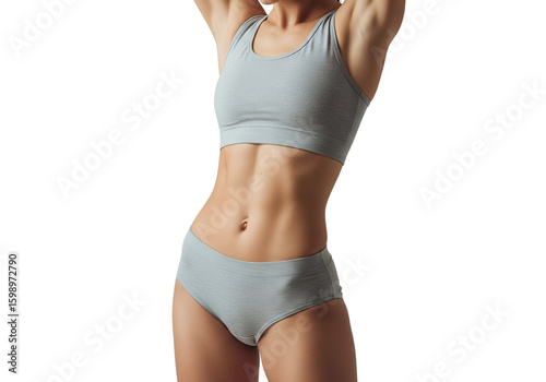 Fit young woman's toned abdomen and waist, displaying healthy physique in light grey activewear.
