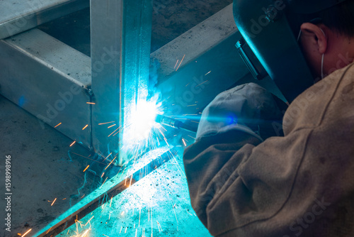 worker welding in a factory at horizonal composition