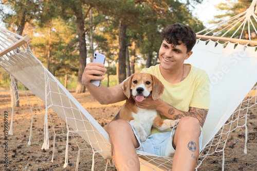 Young man with Beagle dog s...