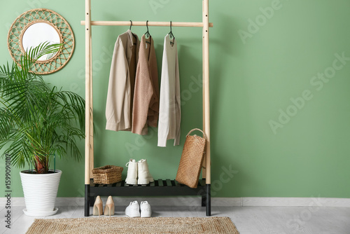 Rack with stylish clothes, ...