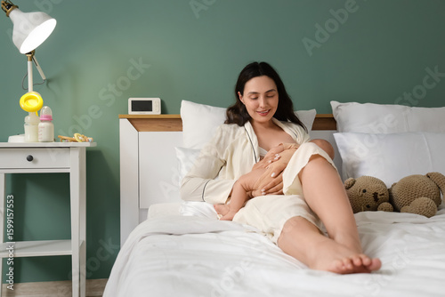 Young woman breastfeeding h...