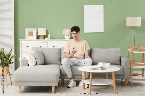 Young man using mobile phon...