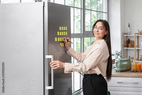 Beautiful businesswoman wri...