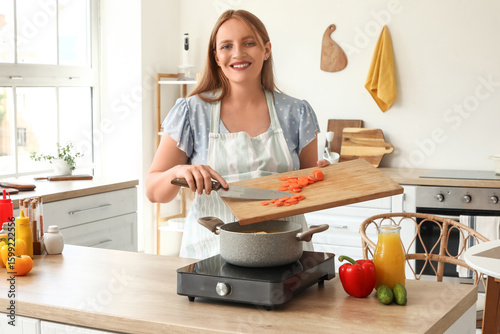 Young pregnant woman making...