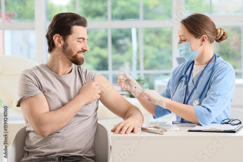 Young man receiving vaccine...