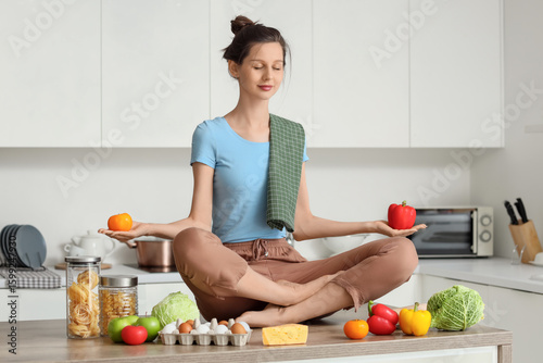 Young housewife meditating ...