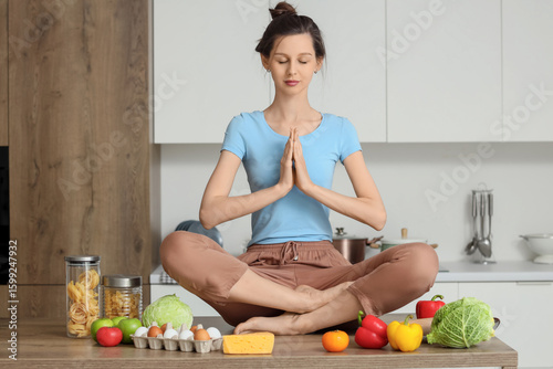 Young housewife meditating ...