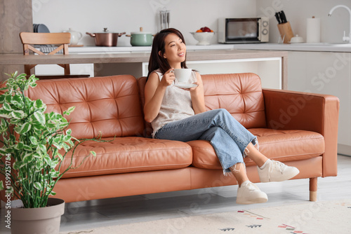 Young Asian woman with cup ...