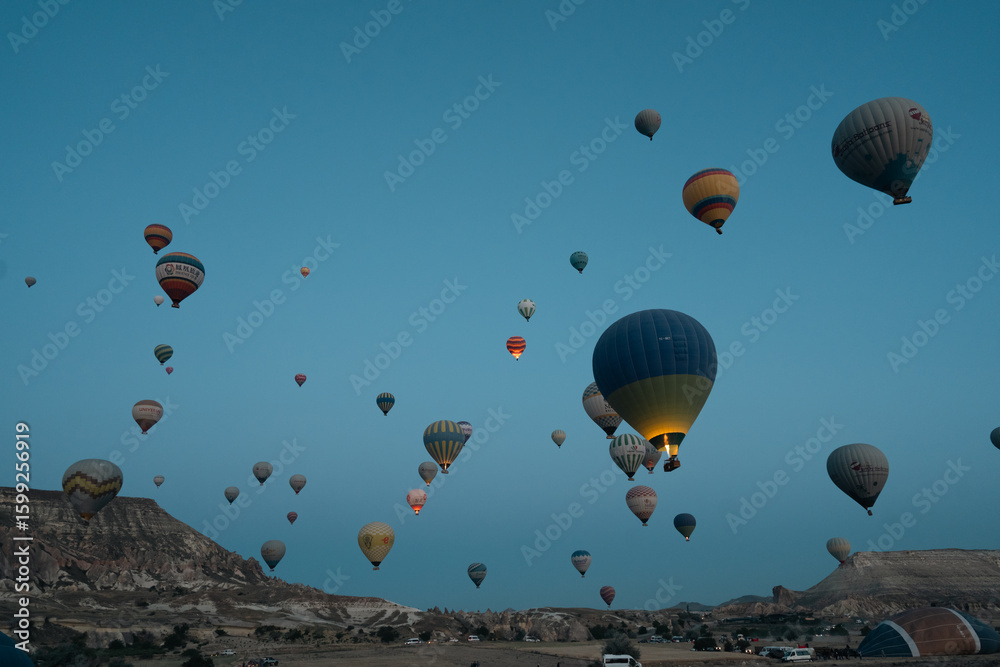 Fototapeta premium Hot Air Balloons in Cappadochia, Turkey as seen from a hot air balloon above the rock formations of Cappadochia