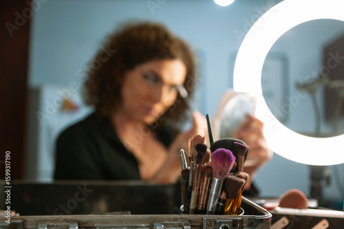 A drag queen putting on her makeup before going out to perform at a local theater in Peru.