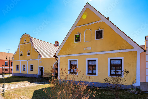 Charming czech village houses with yellow facades under clear blue sky