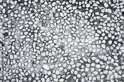 background with sidewalk texture with white pebbles. Natural road surface