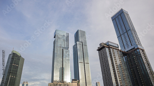 view of a public park with a lake in Jakarta in the morning with a background of modern buildings on the lake side