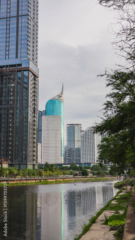 Obraz premium view of a public park with a lake in Jakarta in the morning with a background of modern buildings on the lake side