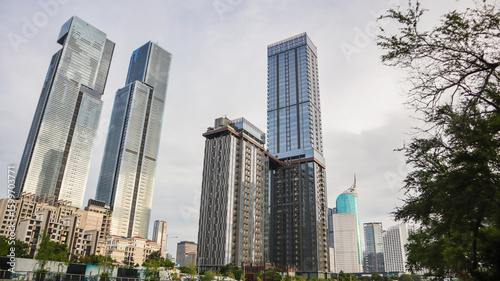 view of a public park with a lake in Jakarta in the morning with a background of modern buildings on the lake side