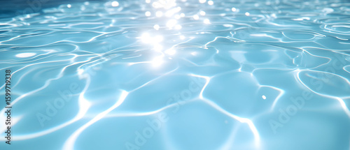 Close-up of rippling blue water surface with light reflection.