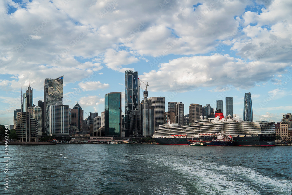 Fototapeta premium Sydney, Australia - 25 January 2025 : Circular Quay ferry wharf with cruise ship view from a boat
