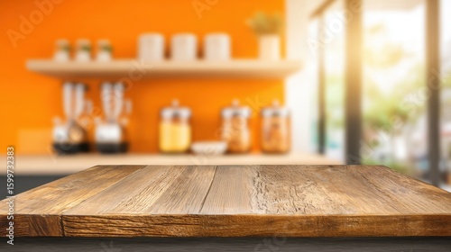 A wooden table surface is displayed prominently in a modern kitchen setting. The background features an orange wall accented by shelves displaying kitchen items, illuminated by natural light.