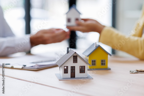 Wallpaper Mural Estate business agent giving house Real estate transaction with agent giving house keys to client over a contract, calculator on table.
 Torontodigital.ca