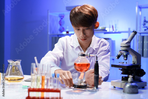 Scientist heating chemical solution in laboratory experiment