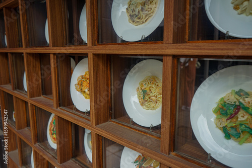 Closeup view of Japanese food models, called shokuhin sampuru, in a window display outside a restaurant in Nara, Japan showing different pasta dishes