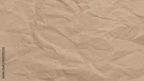 Crumpled kraft old brown paper texture background with copy space for design. Crumpled old brown vintage paper surface texture for background.