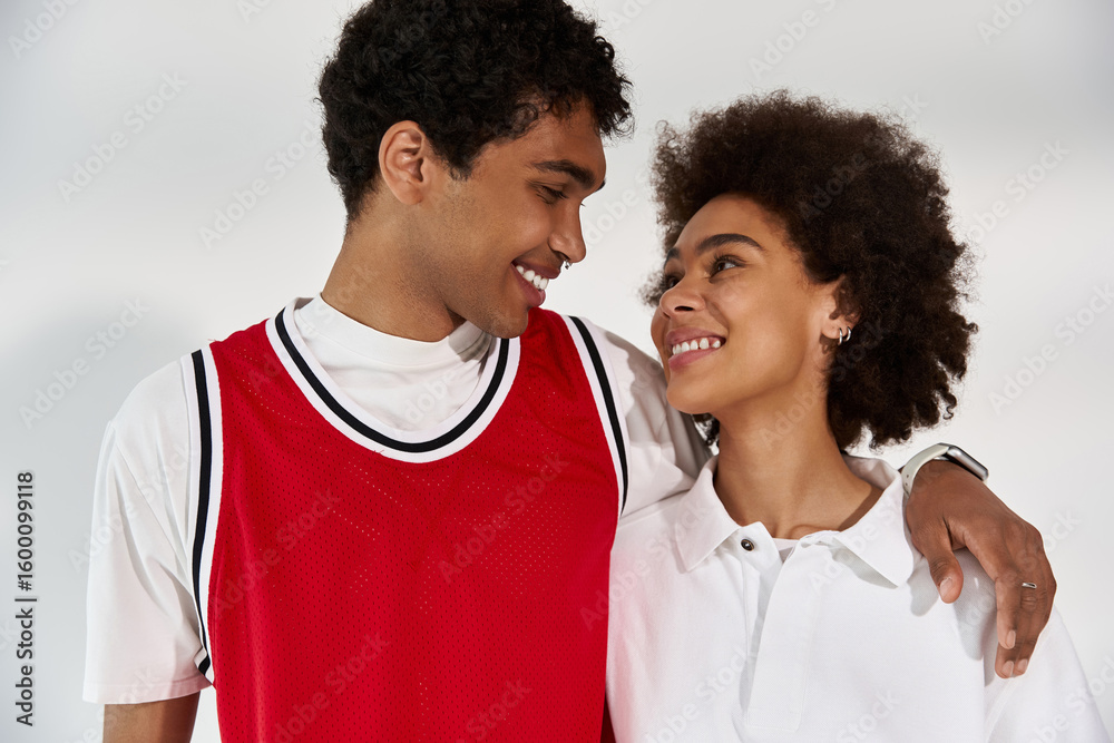 Fototapeta premium Young couple sharing a sweet moment full of love and style in a minimalist setting