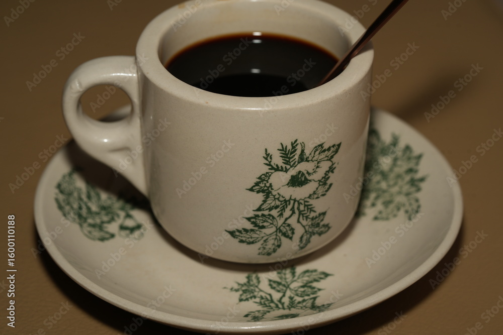 Fototapeta premium Swirling Cream in Ceramic Coffee Cup with Green Patterns