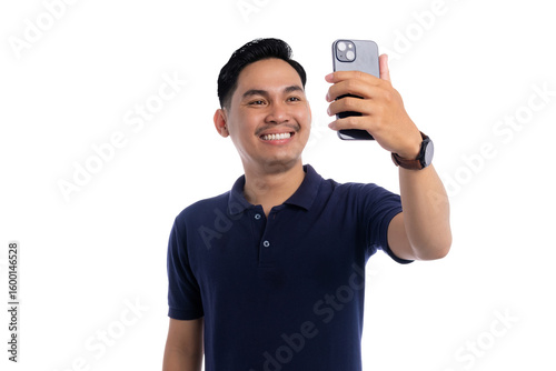 Happy Asian man taking selfie with smartphone while smiling and posing isolated on transparent background