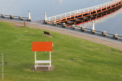 park bench overlooking pier on sea