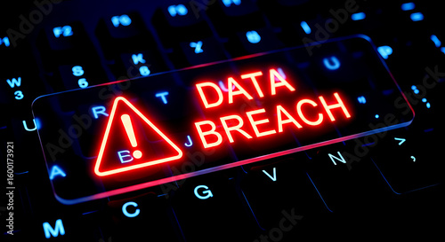 Glowing Red Data Breach Warning Sign on a Dark Keyboard security cyber