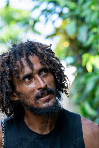 Portrait of a local Costa Rican man with dreadlocks looking up, enjoying the tropical atmosphere of Tortuguero