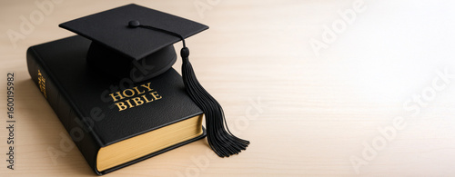 Graduation Cap on Top of Holy Bible

